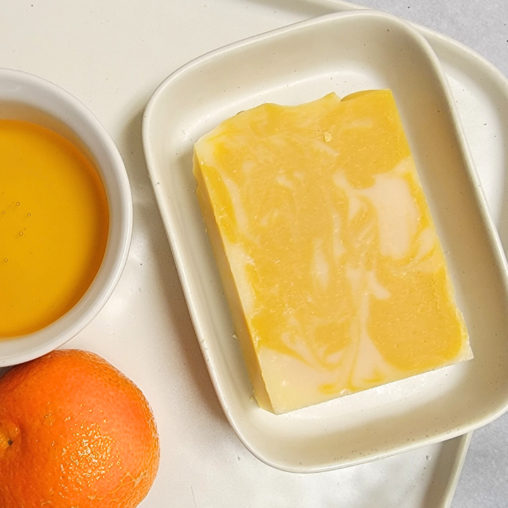 Rejuvenate your skin with the fresh, citrusy scent of Honey Tangerine Natural Handmade Soap. Formulated with moisturizing honey, soothing aloe vera, and antioxidant-rich annatto seed oil, this soap cleanses effectively without stripping natural moisture. The addition of yellow clay and kaolin clay helps purify, while silk fibers create a luxurious, silky lather. Perfect for all skin types, this handcrafted soap leaves your skin feeling soft, smooth, and radiant.