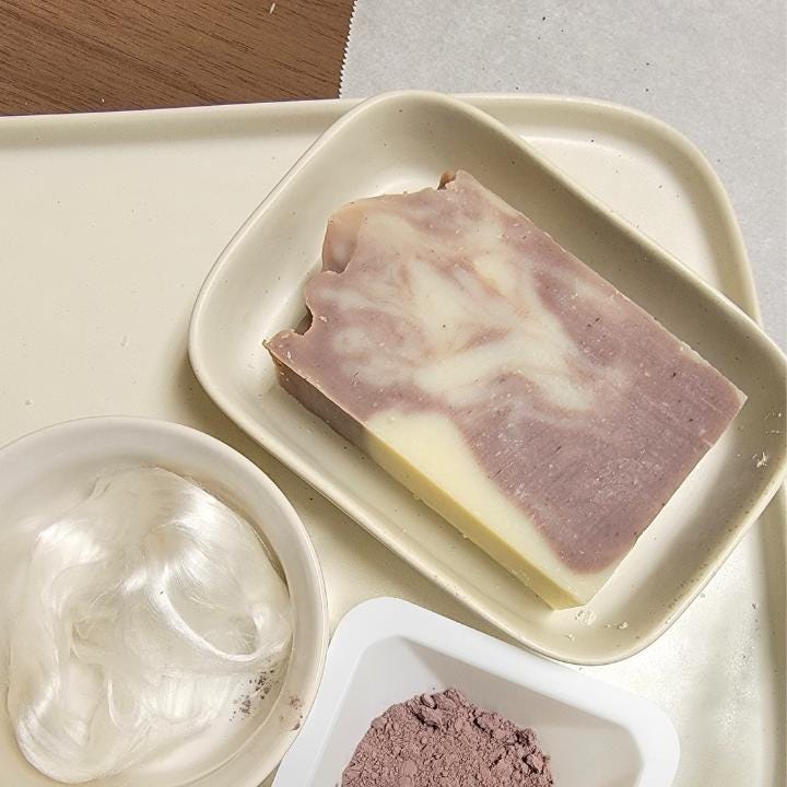 Our natural handmade soap is crafted with a thoughtful blend of nature-sourced ingredients, for a luxurious and nourishing cleansing experience. Rich botanical oils and butters provide deep hydration, while plant-based extracts soothe and protect the skin. We carefully select each ingredient—from creamy coconut milk and raw honey to mineral-rich clays and antioxidant-packed botanicals—to create a formulation that is both gentle and effective. No synthetic fragrances, no artificial colors.